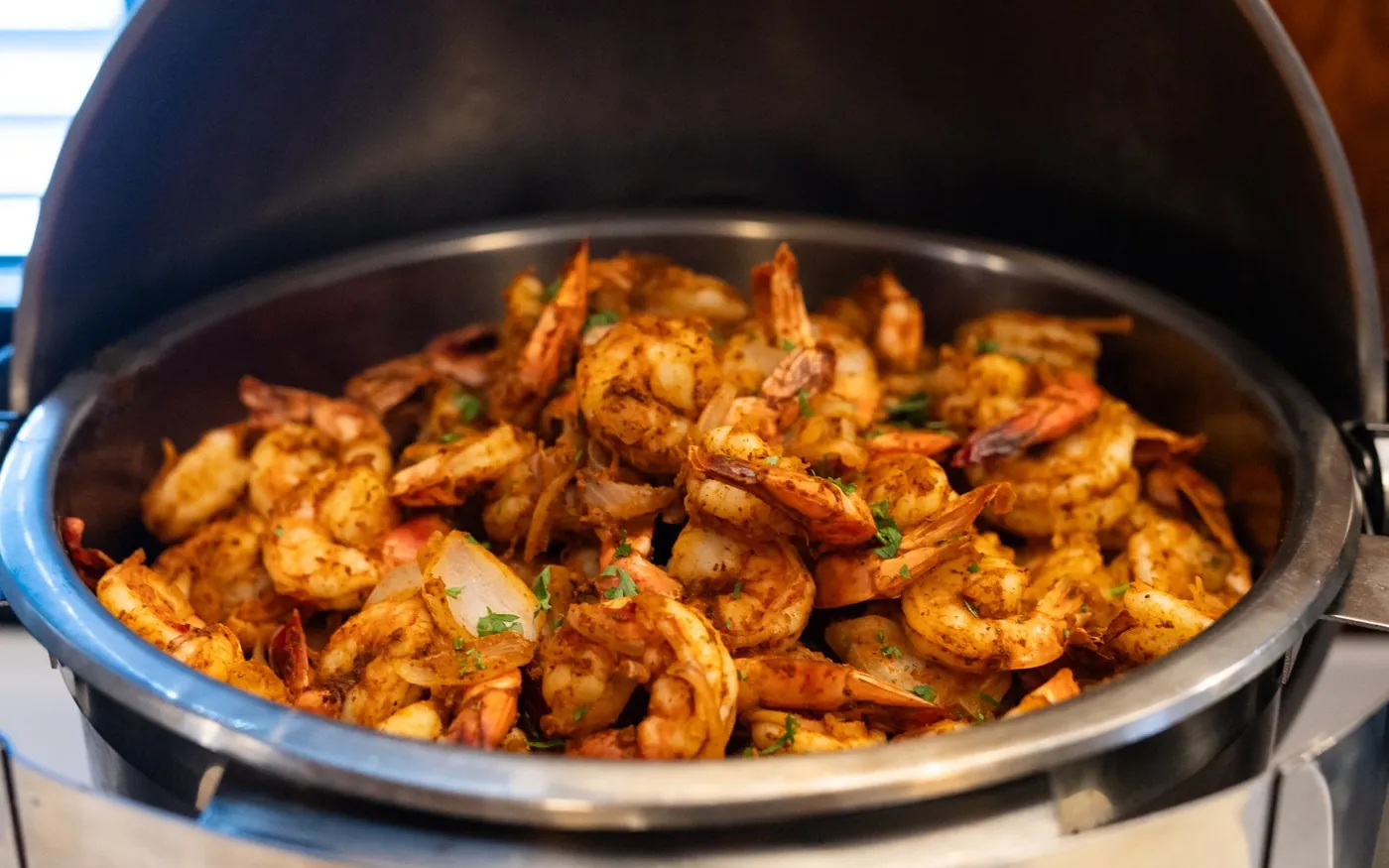 Seasoned shrimp in a chafing dish